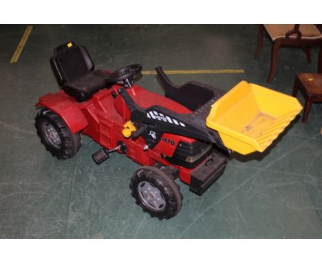 A plastic case pedal tractor or digger 