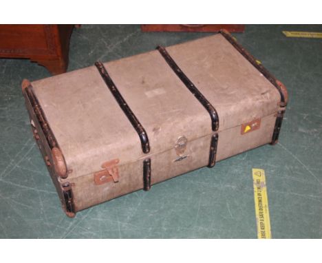 A late 19th/early 20th century canvas trunk, measuring 93 cm long 