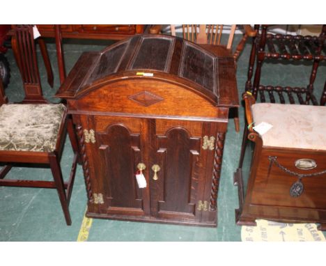 An oak caddy topped cupboard with barley twist columns 