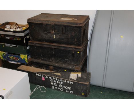A group of three late 19th century black coloured tin and other trunks, together with a wooden ammunition box 