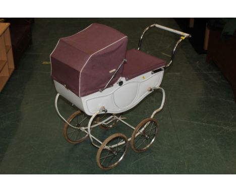 A vintage Tri-ang pram with purple canopy 