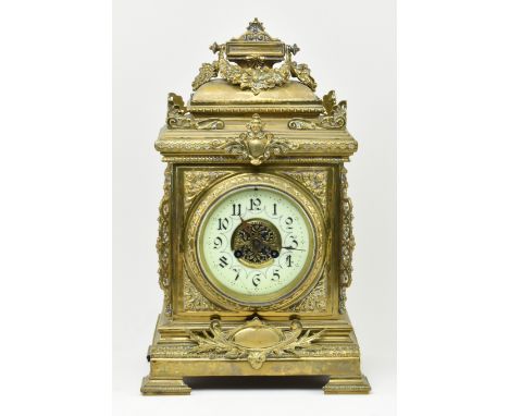 An early 20th century French gilt brass 8 day mantle clock. The clock featuring gilt finial swag, pierced brass fret relief t
