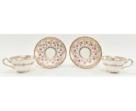 A pair of 19th century English hand painted porcelain tea cups &amp; saucers. Each cup and saucer intricately decorated with 