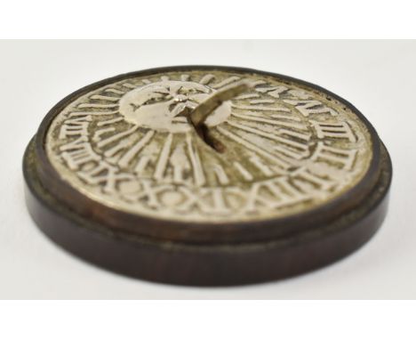 A late 18th century George III miniature travel sundial. The sundial of circular form having a silvered relief decorated cart