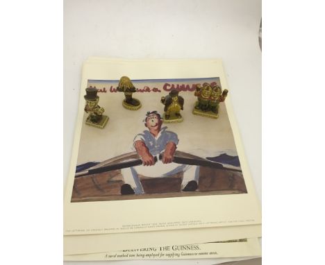 A quantity of original Guinness posters together with 4 guinness ceramic figures