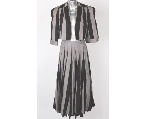 A 1970s red wraparound 100% wool skirt by Christian Dior, the label reads 'Norma Legge N 883'; together with a black and grey
