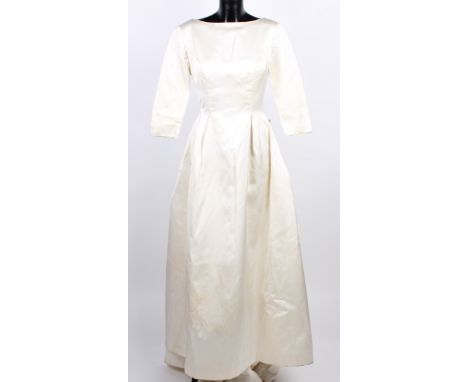 An ivory satin wedding dress and matching shoes, circa 1963; a late 1950s Perlmutt Model pale blue full-length satin bridesma