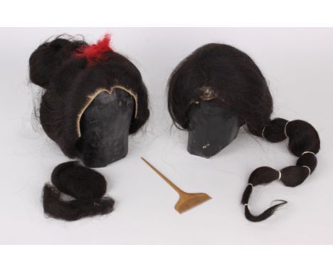 A pair of early 20th Century Japanese real hair Geisha wigs, each wig has a moulded papier-mâché stand lined with Japanese ne