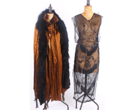 A 1920s black bead and sequin cocktail dress; together with an early 20th Century brown satin evening cape with a Bourne & Ho