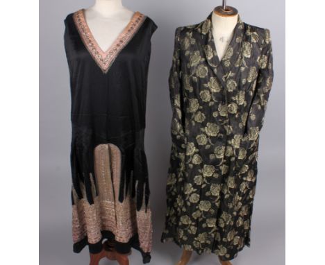 A black satin 1920s dress embellished with silver beads and sequins, a 1950s pink satin deconstructed dress, a black and bron