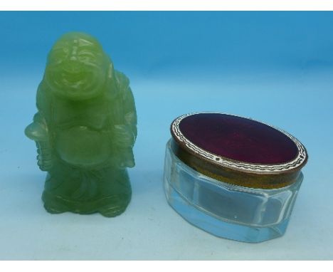 A carved figure and a guilloche enamel topped glass jar