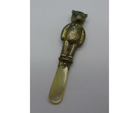 A silver and mother of pearl Teddy bear rattle, a/f, Chester 1958