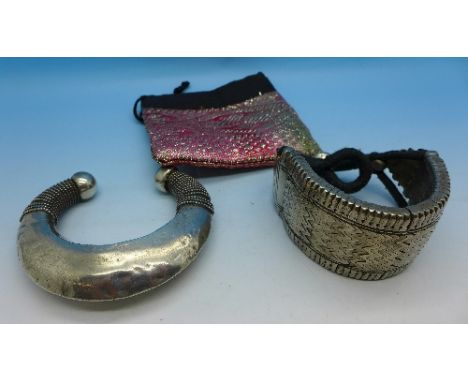 A white metal bangle and bracelet