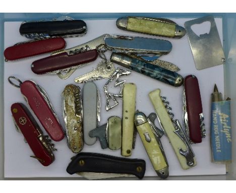 A collection of penknives including Swiss Army, bottle openers, etc.