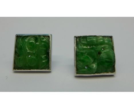 A pair of carved jade and white metal earrings, no fasteners