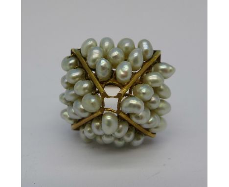 A yellow metal and pearl set ring, continental control marks, lacking two pearls, 7.4g, T