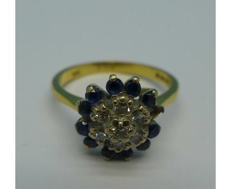 An 18ct gold, diamond and sapphire cluster ring, lacking one blue stone, 3.8g, M