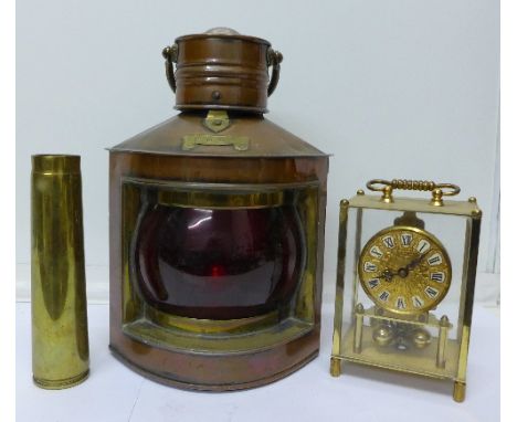 A Kundo clock, trench art shell case and a ship's lamp marked Port