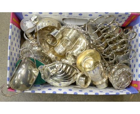 Silver plated items including napkin rings, toast rack, wine coaster, teapot, etc.