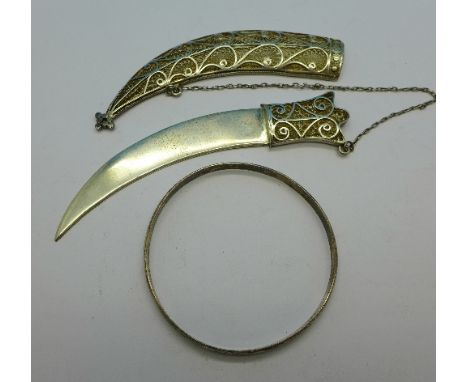 A silver bangle and a white metal filigree knife and scabbard