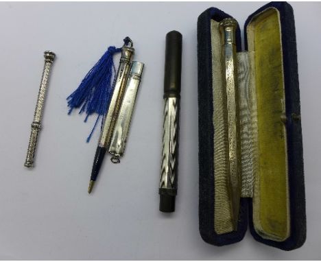 A silver mounted fountain pen with 14k nib and other silver pencils, etc.