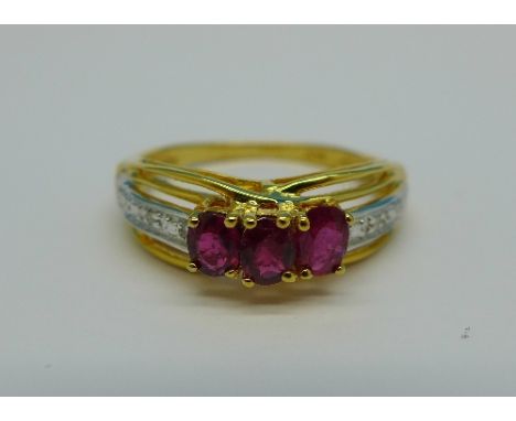 A silver gilt, ruby and diamond ring, M