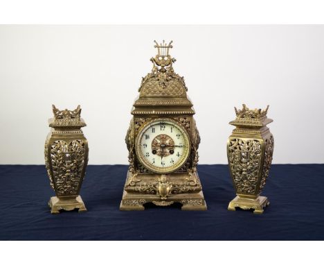 EARLY 20th CENTURY ORNATE AND CAST AND PIERCED BRASS THREE PIECE CLOCK GARNITURE, having spring driven French 8 days movement