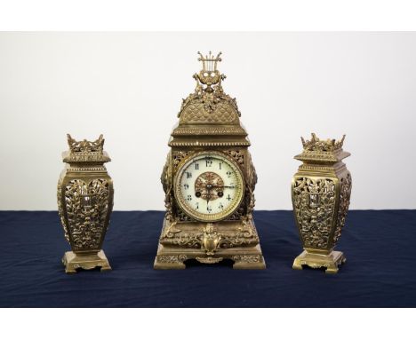 EARLY 20th CENTURY ORNATE AND CAST AND PIERCED BRASS THREE PIECE CLOCK GARNITURE, having spring driven French 8 days movement