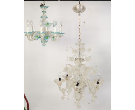 TWO INCOMPLETE TWENTIETH CENTURY MOULDED GLASS SIX LIGHT ELECTROLIERS, one in clear glass, with rings and drops to the scroll