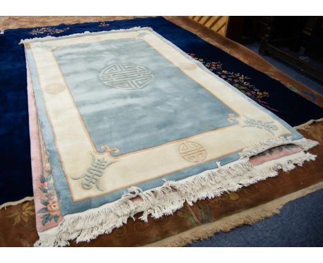 HEAVY QUALITY EMBOSSED WASHED CHINESE CARPET, the plain pale blue field having grey mon medallion, the broad cream border dec