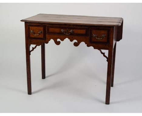 GEORGE III MAHOGANY CROSSBANDED OAK LOW BOY, the moulded top with in-turned fore corners and fall-flap to the back, set above