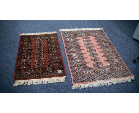 PAKISTAN 'BOKHARA' SMALL RUG with a single row of seven guls, on a wine red field, repeat pattern principal border with guard