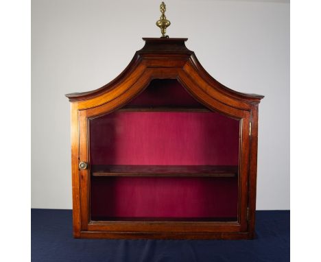 NINETEENTH CENTURY GLAZED WALNUT MURAL DISPLAY CABINET, the moulded pagoda top with brass flame finial, above a conforming, g