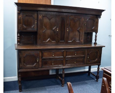 MID/ LATE TWENTIETH CENTURY JACOBEAN STYLE OAK LARGE SIDEBOARD, the canopy back with a central pair of geometric moulded cupb