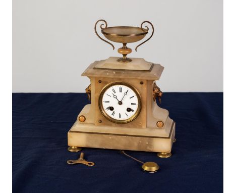 LATE VICTORIAN WHITE ALABASTER AND GILT METAL MANTEL CLOCK, of architectural form with two handle urn surmounting, the 8 day 