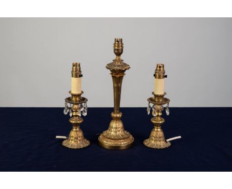 THREE SIMILAR, MODERN CAST BRASS ELECTRIC TABLE LAMP BASES, one of tapering form with leaf cast circular base, 14? (35.6cm) h