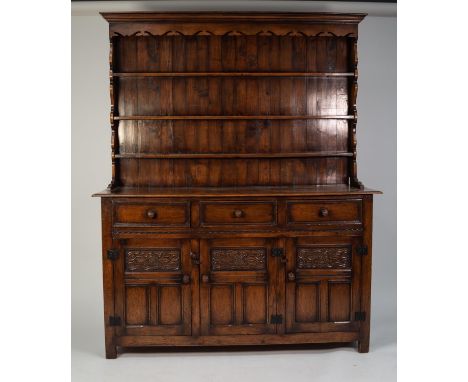 PROBABLY BEVAN FUNNELL, MODERN REPRODUCTION CARVED ELM WELSH DRESSER, the panelled plate rack with three shelves and fret cut