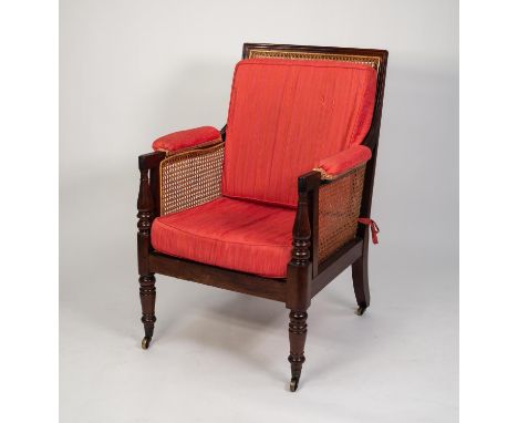 EARLY NINETEENTH CENTURY MAHOGANY BERGERE EASY ARMCHAIR, the square, moulded show wood frame with elbow pads and turned termi