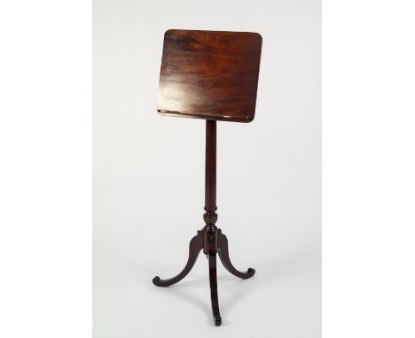 FIGURED MAHOGANY MUSIC STAND, the solid, rounded oblong holder with gilt metal fittings, raised on a turned and slightly tape