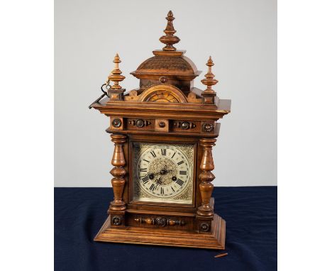 LATE 19th/EARLY 20th CENTURY GERMAN WALNUT CASED MANTEL CLOCK with Junghans movement striking on a coiled gong, with elaborat