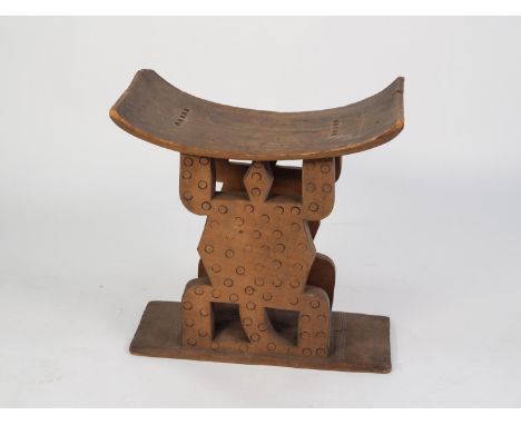 AFRICAN CARVED BLOND WOOD ASHANTI STOOL, of typical form, with standing lizard pattern supports, 22? (56cm) high, 22? x 13? (