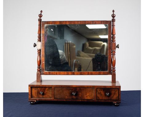 GEORGIAN FIGURED MAHOGANY AND EBONY LINE INLAID TOILET MIRROR, the oblong plate in a crossbanded frame, flanked by slender tu