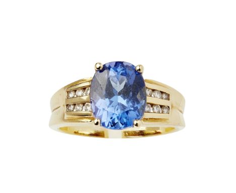 A contemporary Tanzanite and diamond set ringclaw set with an oval cut Tanzanite, each shoulder channel set with two rows of 