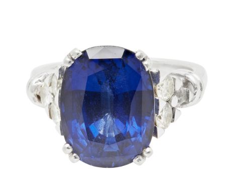 A sapphire and diamond set cocktail ringclaw set with a cushion cut sapphire, each shoulder set with three round brilliant cu