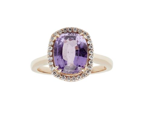 A purple colour-change sapphire and diamond cluster ringclaw set with a cushion cut purple colour-change sapphire, in a singl