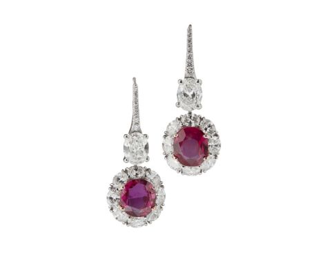 A pair of Burmese ruby and diamond set pendant earringseach claw set with an oval cut ruby in a border of eight oval cut diam