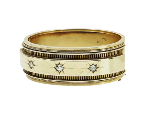 A Victorian diamond set bangleof broad hinged design, set with three cushion cut diamonds, with ribbed and rope twist detail,
