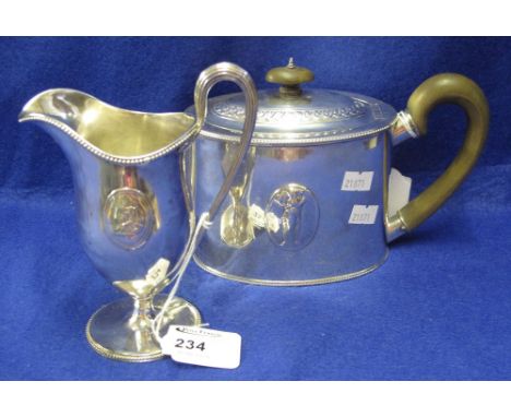 Georgian silver oval section teapot with repousse figural decoration and beaded edges together with a matching pedestal helme