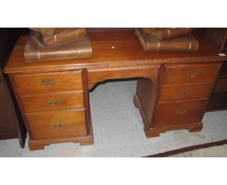 20th Century mahogany knee hole desk, having three drawers to each pedestal.