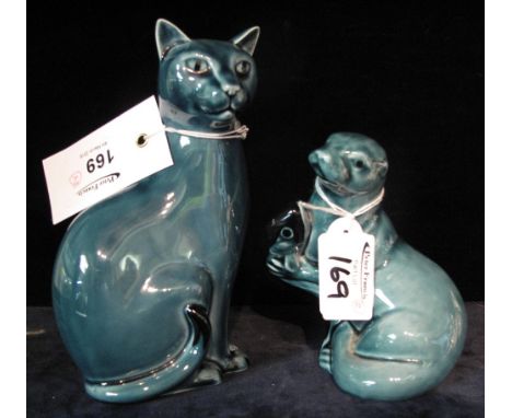 A Poole pottery seated cat and similar sealion with fish. Printed marks. (2)